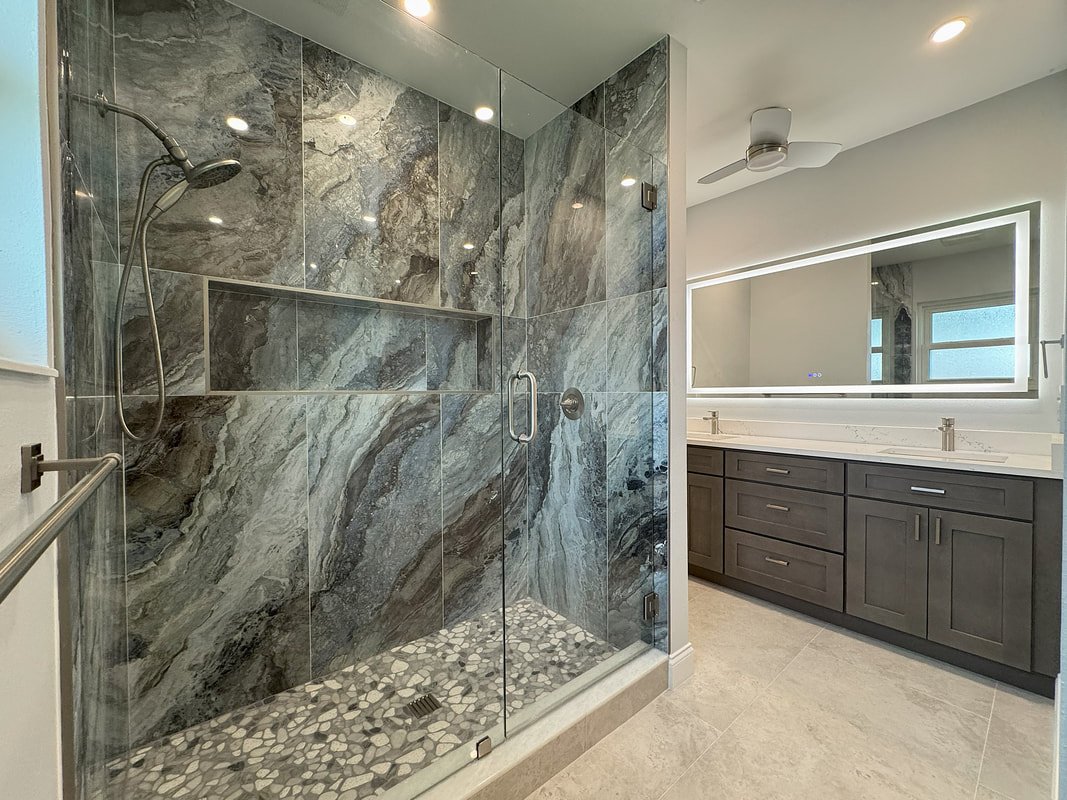 Marble bathroom remodel with glass shower enclosure